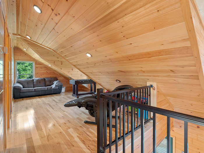 At the top of the stairs is a loft area with a foosball table, a recliner that massages your back, and a queen sized sleeper sofa.