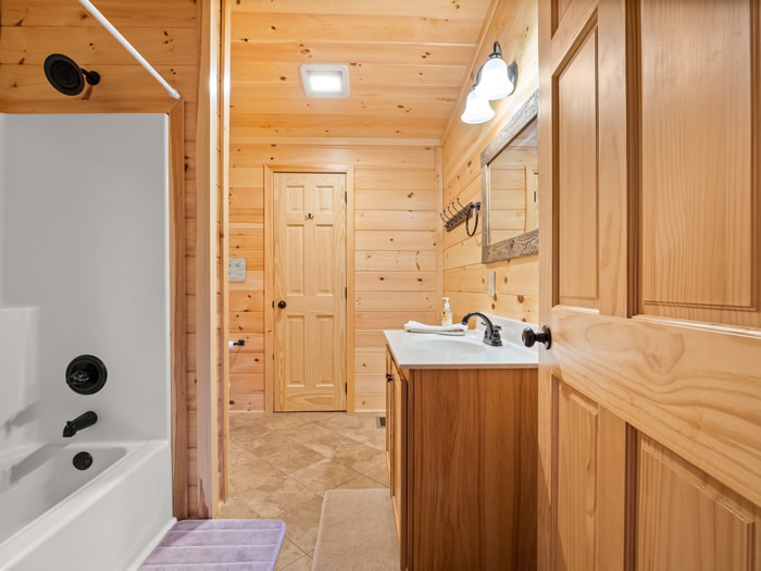 The upstairs bathroom has a single lavatory and a tub/shower combo.