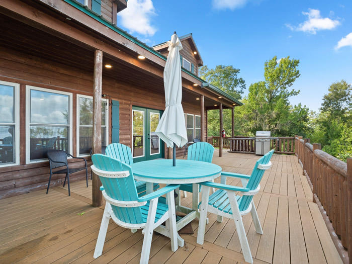 The deck on the outside of the cabin is oversized and has a umbrella, chairs, and a gas grill. The flooring is composite so that you can walk around barefoot and not get a splinter in your foot.