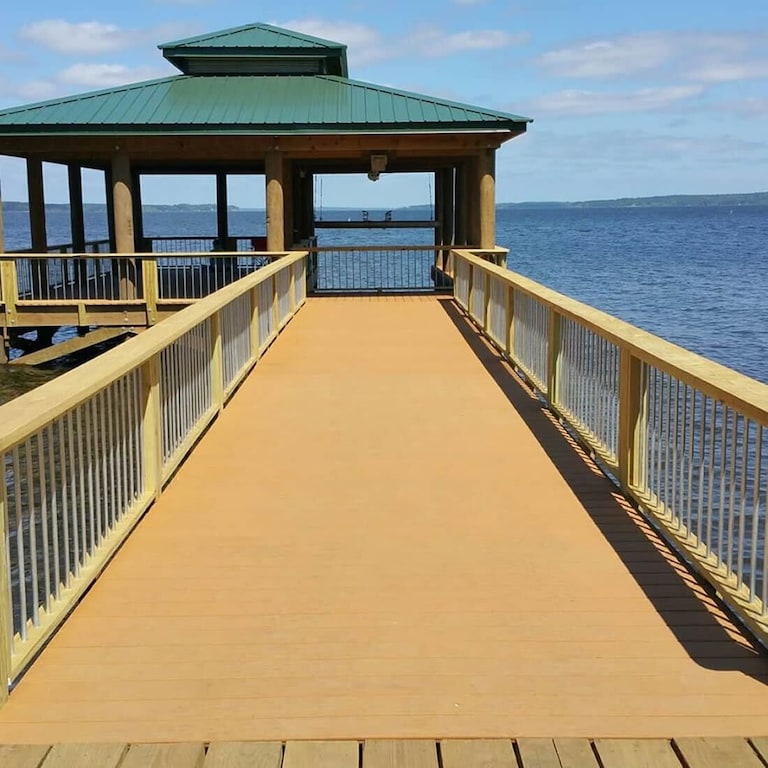 Boathouse with boat lift and gathering area.