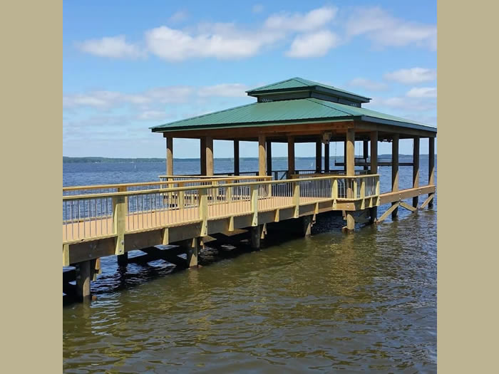 Boathouse with boat lift and gathering area.