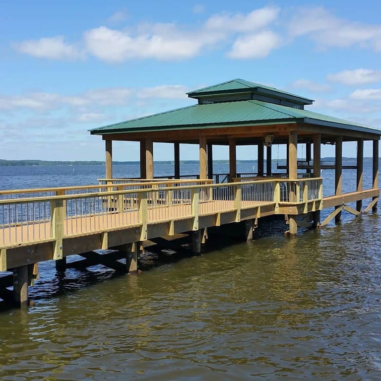 Boathouse with boat lift and gathering area.