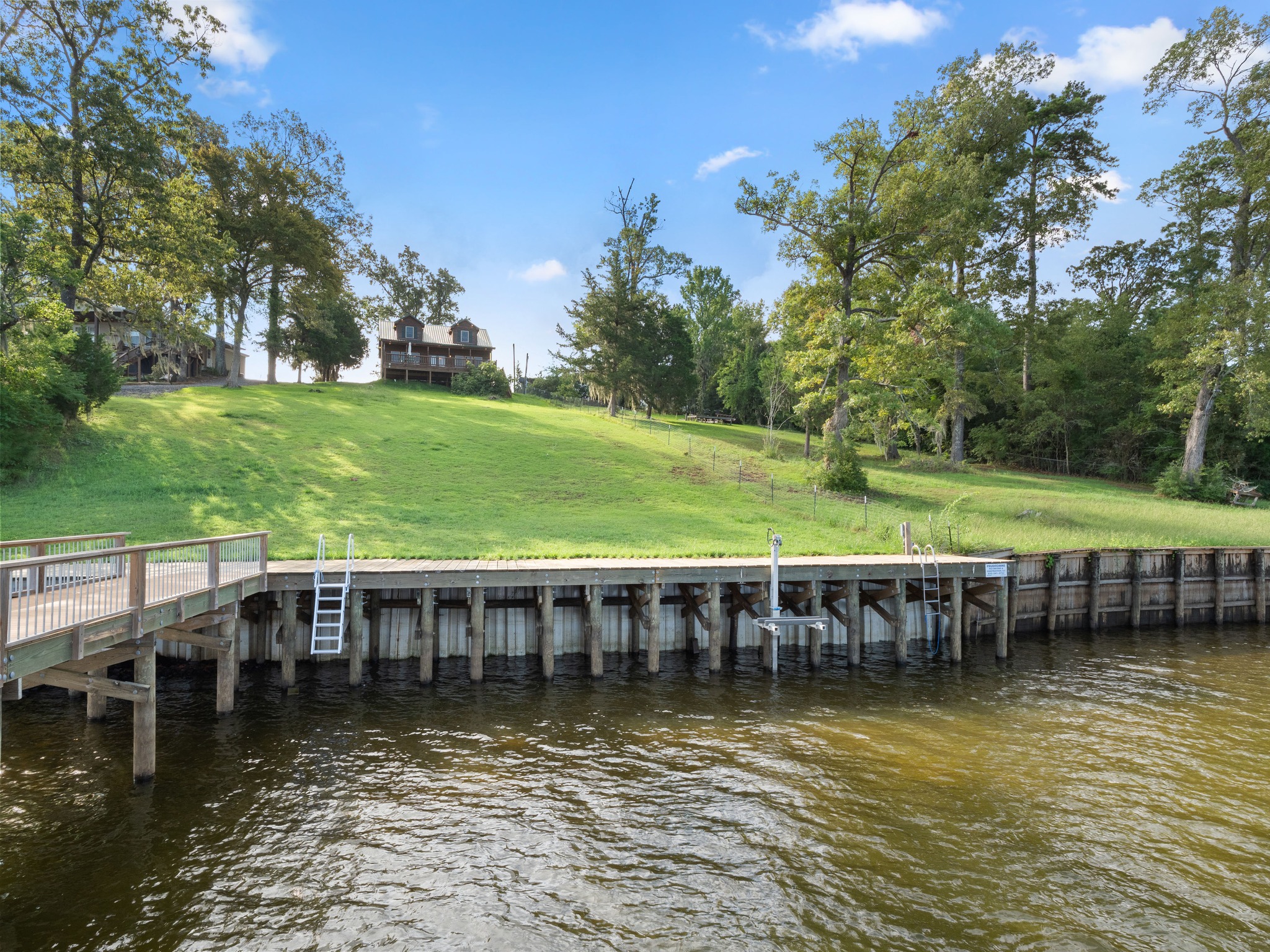 This is the view looking back at the cabin from the boathouse. There are a couple of ladders and a jet ski lift to help with getting into and out of the water.